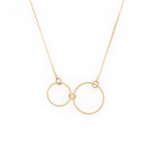 Gold necklace with two small gold circles on a white background by Bird of Virtue
