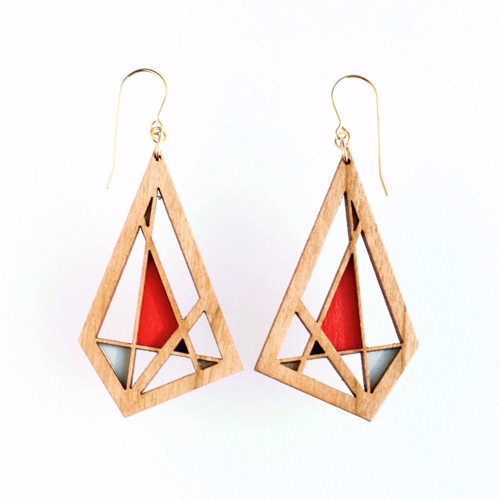 Medium toned cherry wood geometric earrings with gold french hooks with sections painted in metallic gold, bright red and aqua