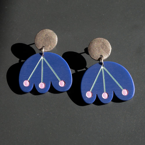 Blue flower earrings with pink dots dangle from circular silver post by Bird of Virtue