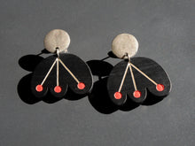 Black flower earrings with red dots dangle from circular silver post by Bird of Virtue