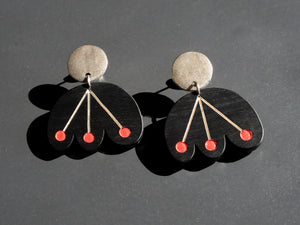 Black flower earrings with red dots dangle from circular silver post by Bird of Virtue