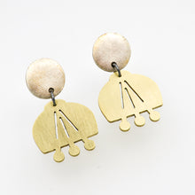 Pair of brass earrings on a white background