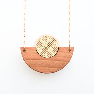 Detail image of caramel brown wood, metallic gold and bone white semicircle necklace with gold chain by Bird of Virtue