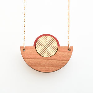 Detail image of caramel brown wood, metallic gold and rust semicircle necklace with gold chain by Bird of Virtue