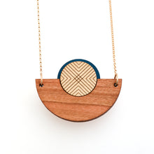Detail image of caramel brown wood, metallic gold and blue semicircle necklace with gold chain by Bird of Virtue
