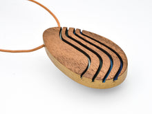 Wooden pendant with wavy design on a white background