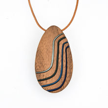 Wooden pendant with a leather cord on a white background