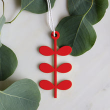 Red modern flower metal ornament with geometric leaf tiers, Scandinavian design, on hemp cord