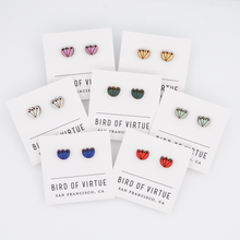 A display of colorful stud earrings with floral designs on white cards from Bird of Virtue, San Francisco. Featuring red, gold, silver, cobalt, mint, green and orchid.