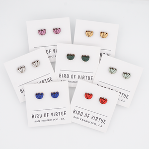 A display of colorful stud earrings with floral designs on white cards from Bird of Virtue, San Francisco. Featuring red, gold, silver, cobalt, mint, green and orchid.