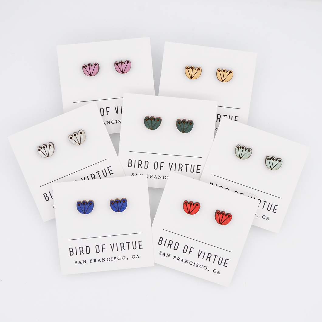 A display of colorful stud earrings with floral designs on white cards from Bird of Virtue, San Francisco. Featuring red, gold, silver, cobalt, mint, green and orchid.