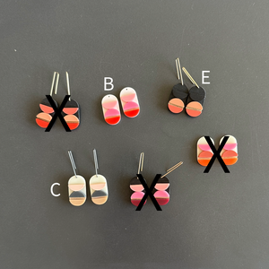 Set of ovat-shaped earrings on a dark gray background