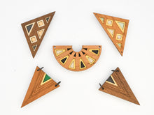 Set of geometric wooden wall pendants on a white background