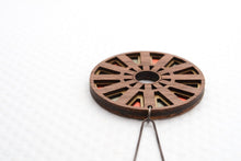 Circular wood pendant on white background