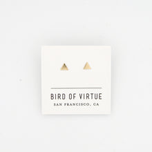 Tiny gold triangle stud earrings on white Bird of Virtue card, on white background